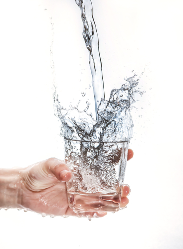 Water splashing into a glass