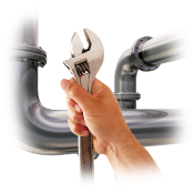 Pipes with a hand holding a wrench in the foreground