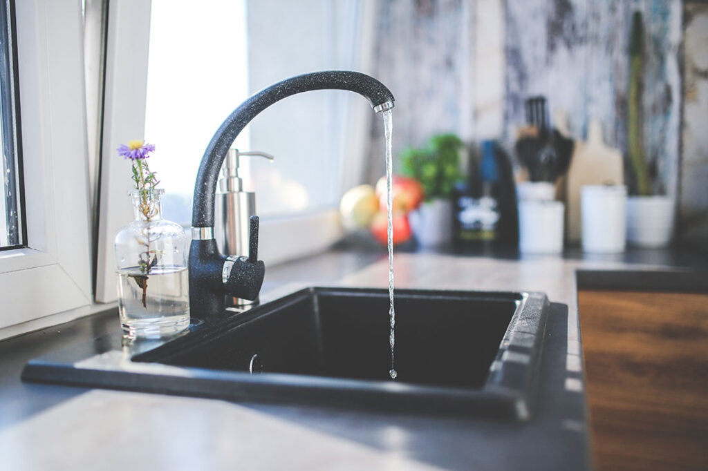 A running faucet in a kitchen