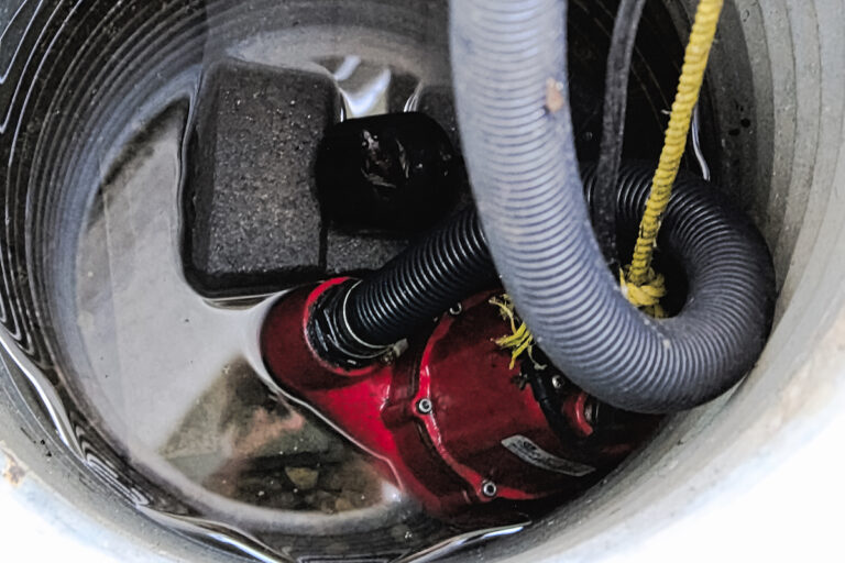 A sump pump with some water around it.