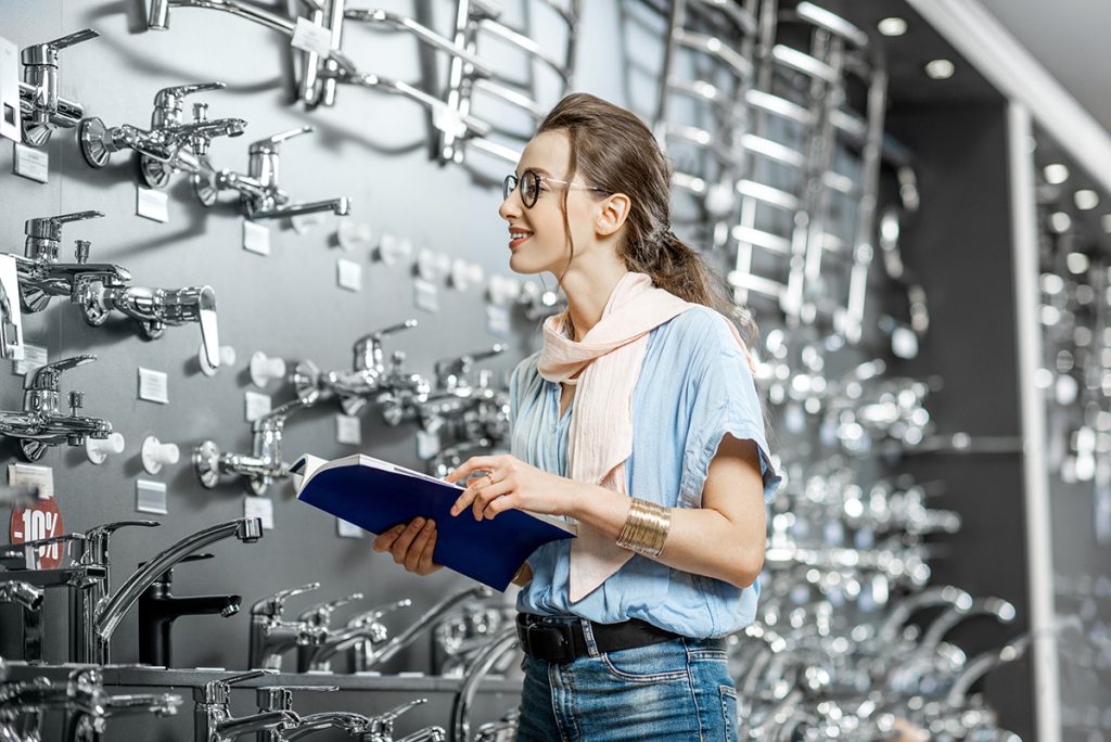 Woman looking at faucets and plumbing fixtures