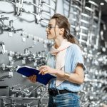 Woman looking at faucets and plumbing fixtures