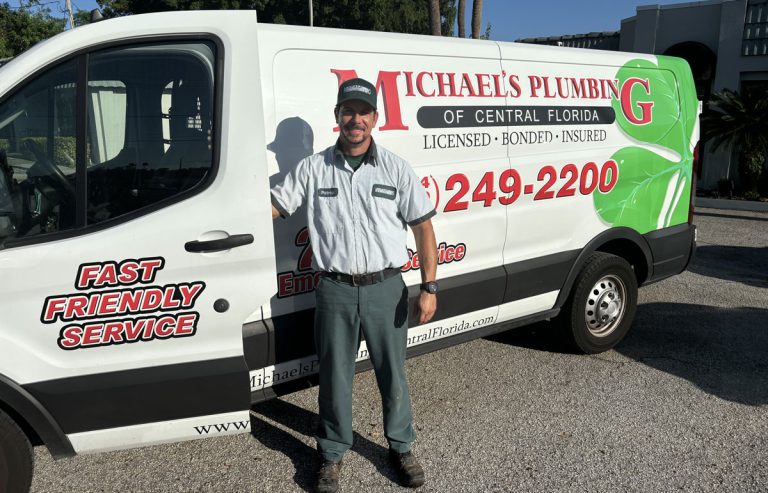 Plumber next to a service van